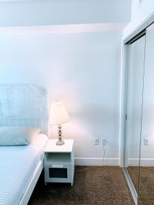 a bedroom with a bed and a lamp on a table at Western Melrose in Los Angeles