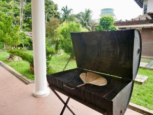 a grill with a shell on top of it at Homestay Cozy PD Villa, Port Dickson in Port Dickson