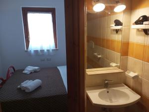 a small bathroom with a sink and a mirror at Accomodation Villa Florio Parghelia in Fitili +61 photos