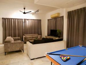 a living room with a pool table in the middle of it at Homestay Cozy PD Villa, Port Dickson in Port Dickson