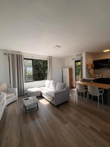 a living room with a white couch and a table at Roof Top in Moka