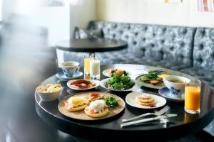 a table with plates of food on top of it at Park Hotel Tokyo in Tokyo