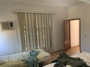 a room with two beds and a sliding glass door at Casa Fátima in Tequesquitengo +14 photos