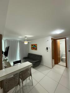ein Wohnzimmer mit Sofa und Tisch in der Unterkunft Israel Flat beira-mar in João Pessoa