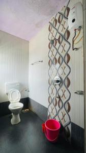 a bathroom with a toilet and a shower at Vamoose Kaas Hill Resort in Kanera