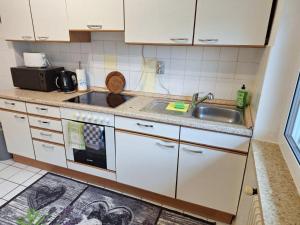 a kitchen with a sink and a stove top oven at 4 Zimmerwohnung in Schöneck in Schoneck