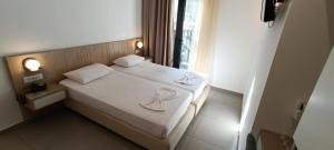 Posteľ alebo postele v izbe v ubytovaní Catherine Hotel
