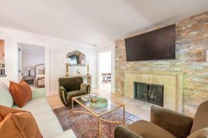 a living room with a fireplace with a flat screen tv at New Listing 3 BR 3 BA Aspen Condo near Gondola in Aspen