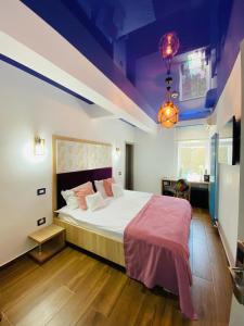 a bedroom with a large bed and a purple ceiling at HOTEL MAREA NEAGRA Mamaia in Mamaia +54 photos