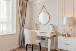 a white desk with a chair and a mirror at 云深处江景公寓 in Chongqing