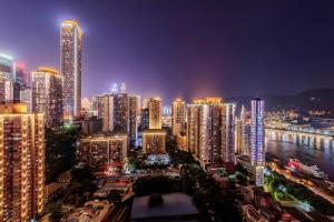 a city lit up at night with tall buildings at 云深处江景公寓 in Chongqing