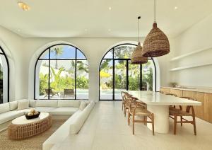 a living room with a white couch and a table at Dolce x The Young Villas in Uluwatu