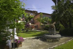 a garden with a bench in front of a house at Grand Tour Resort in Pisa