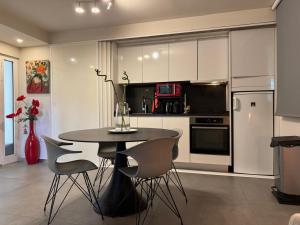 a kitchen with a table and chairs in a room at Cannes, Mougins, Sophia-Antipolis, Grasse, Nice, Monaco, Saint-Tropez in Mougins