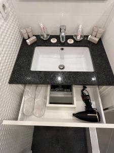 a bathroom sink with a black counter top at Cannes, Mougins, Sophia-Antipolis, Grasse, Nice, Monaco, Saint-Tropez in Mougins +17 photos
