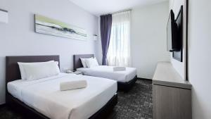 Postelja oz. postelje v sobi nastanitve Amansari Hotel Nusajaya