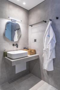 a bathroom with a sink and a mirror at Milva Mare Luxury Apartments in Kos Town +198 photos