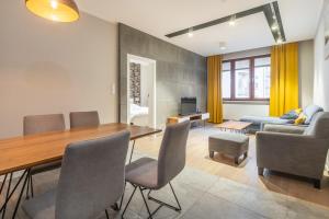 a living room with a table and a couch at Zabrska 18 Spacious Apartment by BookingHost in Katowice