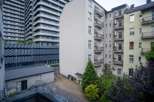 an external view of a tall white building at Zabrska 18 Spacious Apartment by BookingHost in Katowice