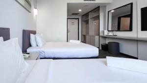 Postelja oz. postelje v sobi nastanitve Amansari Hotel Nusajaya