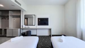 Postelja oz. postelje v sobi nastanitve Amansari Hotel Nusajaya