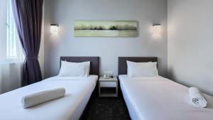 Postelja oz. postelje v sobi nastanitve Amansari Hotel Nusajaya
