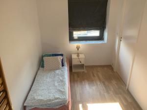 a small room with two beds and a window at Peer Gynts vei 77 in Moss