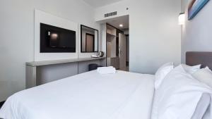 Postelja oz. postelje v sobi nastanitve Amansari Hotel Nusajaya