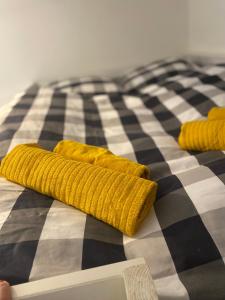 Una cama en blanco y negro con almohadas amarillas. en Apartmán Na Manhattanu, en Rokytnice nad Jizerou