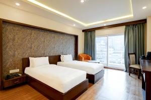 Postel nebo postele na pokoji v ubytování Hotel Cozy Cave Delhi
