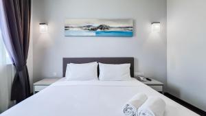 Postelja oz. postelje v sobi nastanitve Amansari Hotel Nusajaya