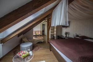 a bedroom with a bed and a table with fruit on it at Hotel Peregrin in Český Krumlov +76 photos