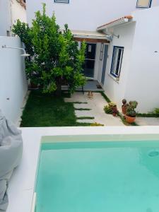 a view of a house from the outside of a swimming pool at Casa das Cantonas Valada in Valada