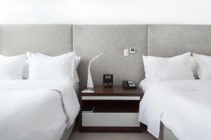Ein Bett oder Betten in einem Zimmer der Unterkunft Radisson Hotel Decapolis Miraflores