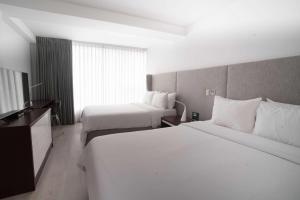 Ein Bett oder Betten in einem Zimmer der Unterkunft Radisson Hotel Decapolis Miraflores