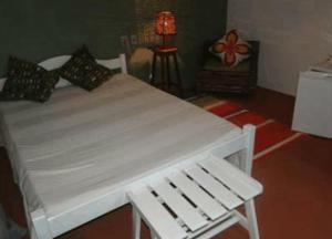 Ένα ή περισσότερα κρεβάτια σε δωμάτιο στο Pousada 100 Passos