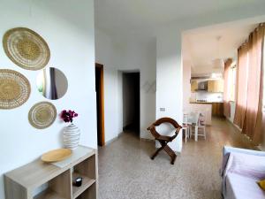 a living room with a couch and a table at Appartamenti vistAmare - La casa del vento in Vibonati