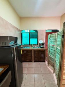 a kitchen with a sink and a refrigerator at Departamento Fila in Puerto Escondido