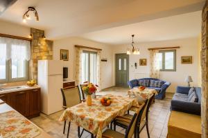 a kitchen and a living room with a table and chairs at Filistron Seaview Nest - Views, Comfort & Calm in Taktikoúpolis