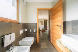 a bathroom with a sink and a toilet at Apartment Egghof im Weingut in Merano +35 photos