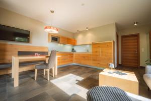a living room with a desk and a tv and a couch at Apartment Egghof im Weingut in Merano