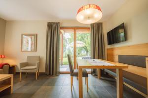 a dining room with a table and chairs and a window at Apartment Egghof im Weingut in Merano