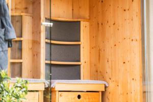 a wooden wall with a wooden chair in a room at Apartment Egghof im Weingut in Merano