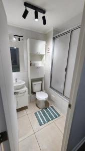 a white bathroom with a toilet and a sink at Comfortable y central depto 2D 2B with parking in Los Ángeles