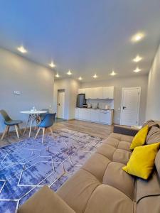 a living room with a large couch and a table at Kolsay Lakes in Saty +24 photos