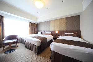 Кровать или кровати в номере Hotel Metropolitan Nagano