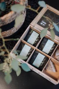 a box of wine bottles on a table with a plant at Brīvdienu māja Sniegi in Madona