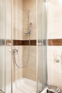 a shower with a glass door in a bathroom at Apartments-Rooms Kocijancic in Bled
