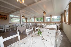 a dining room with white tables and white chairs at Agriturismo Country Casale Rufo in Sonnino +101 photos