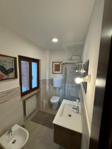 a bathroom with a sink and a toilet and a window at Al vecchio convento, centro storico in Gorizia
